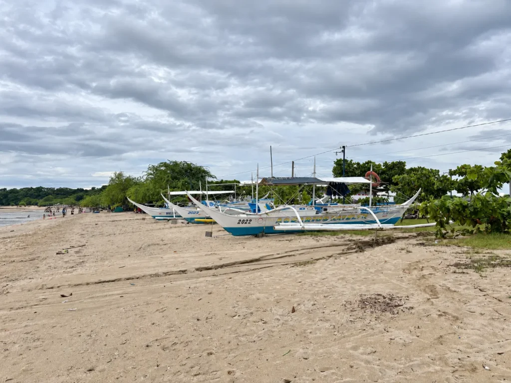 Manuel Uy beachfront with outrigger boats on the sand