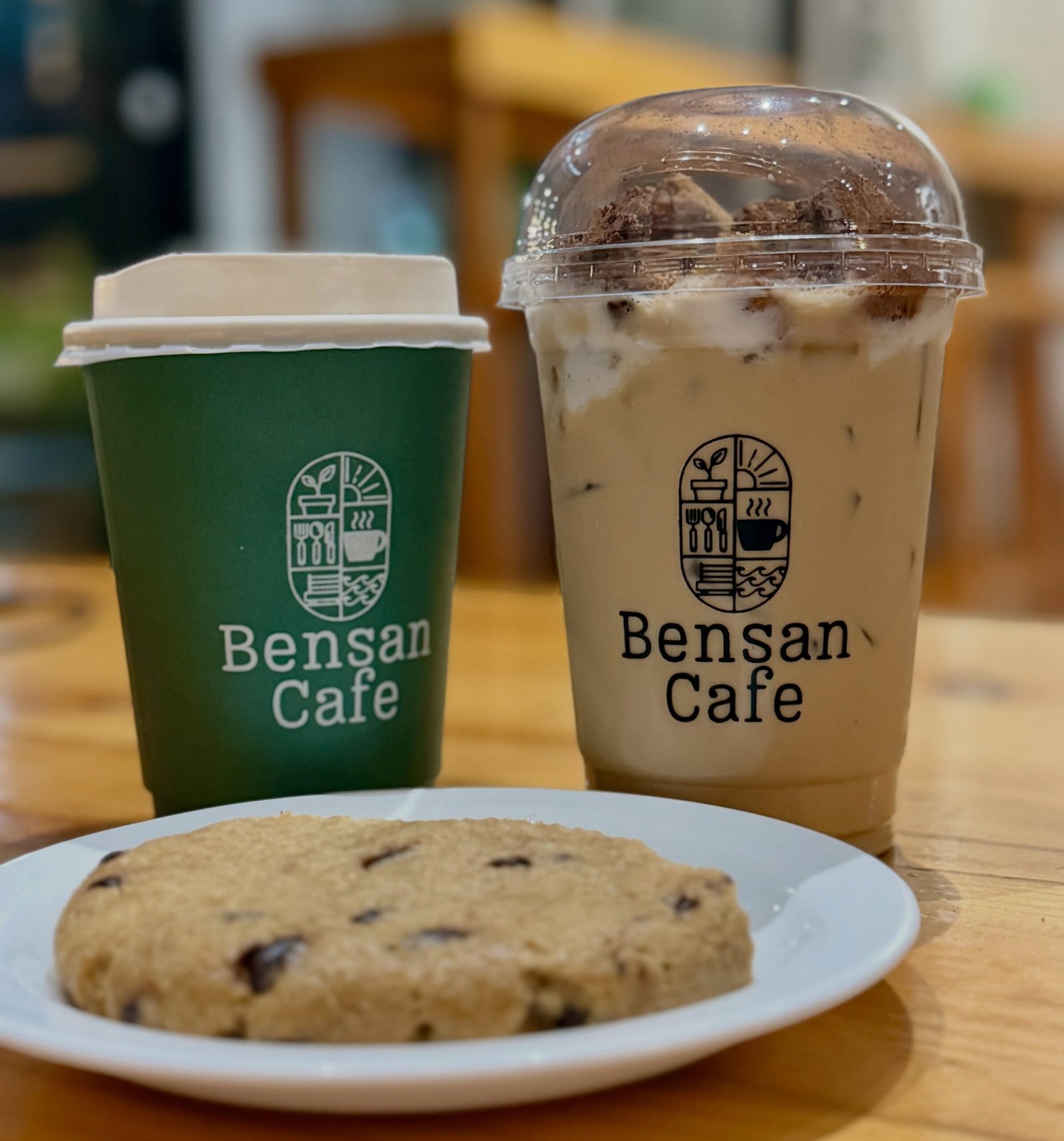 Bensan Cafe branded coffee cups and cookie on a plate