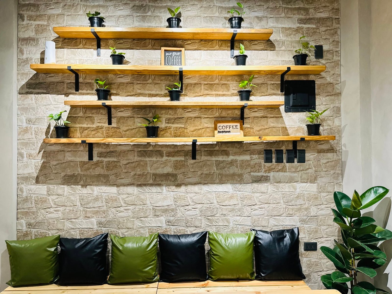 Bench seating and plant-lined wooden shelves at Bensan Cafe