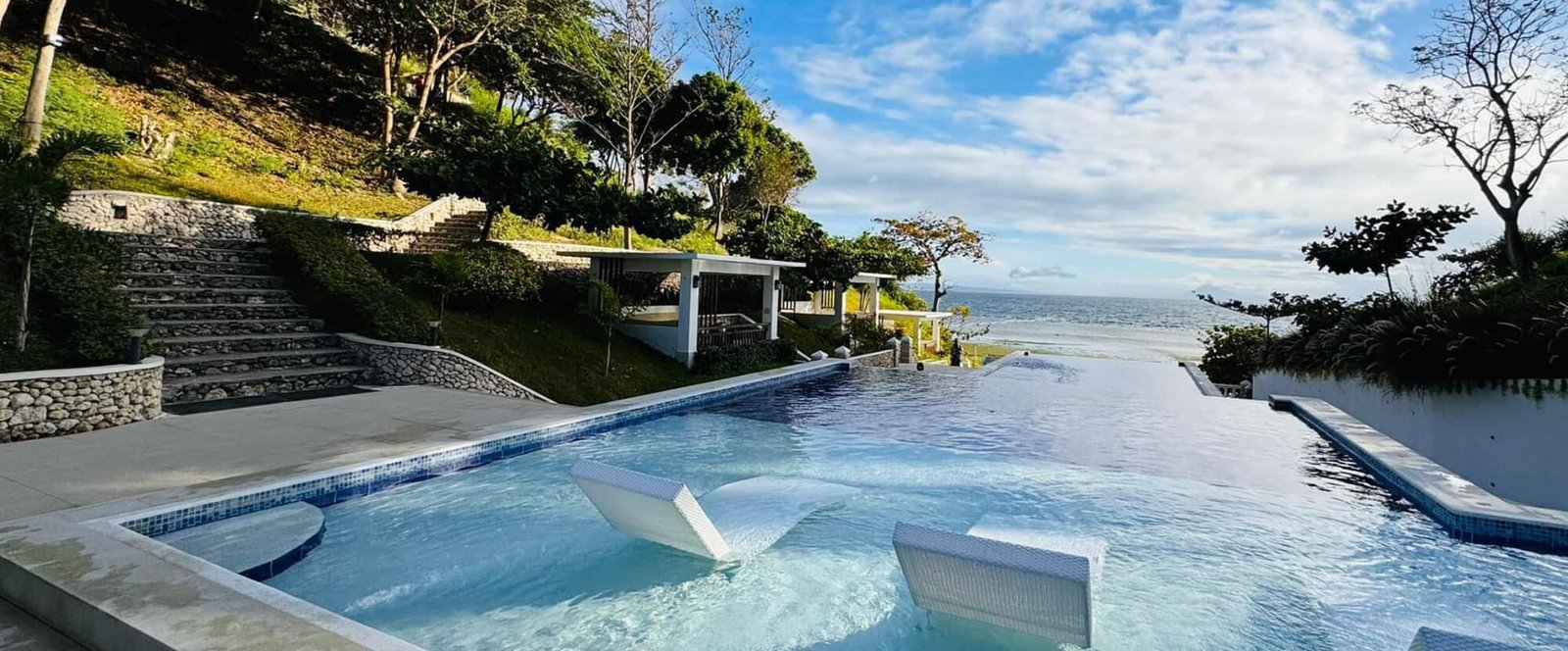 Swimming pool overlooking the sea at Calumbuyan Point Resort