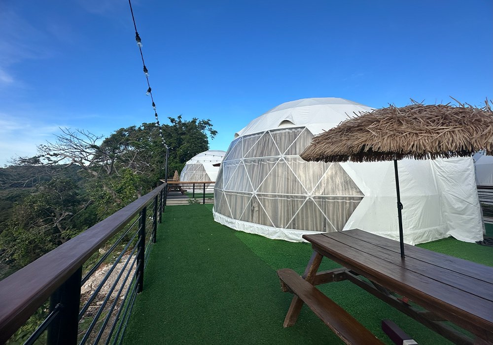 Glamping domes beside a deck at Calumbuyan Point Resort