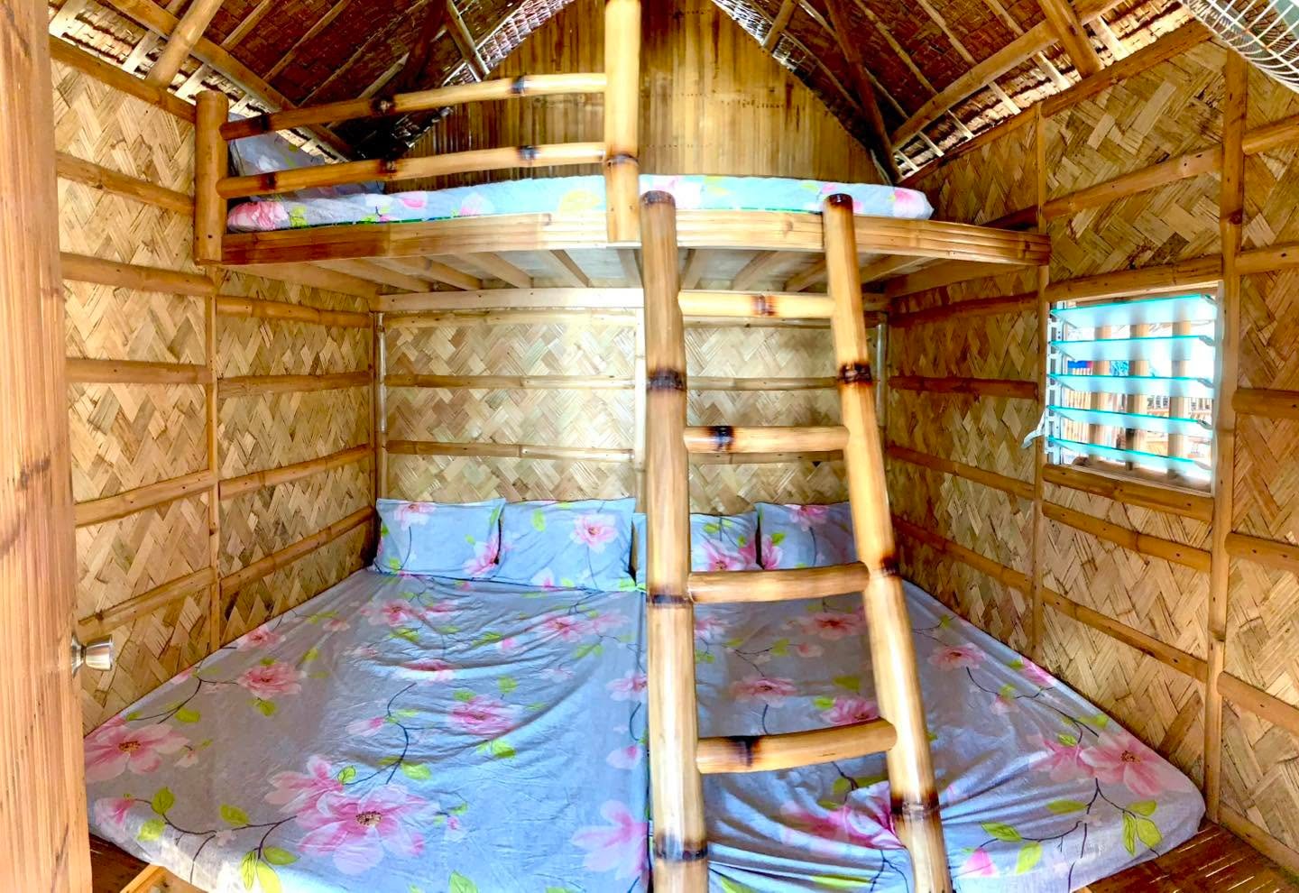 Bamboo bunk beds inside a cottage at Camp Wagi Beach Resort