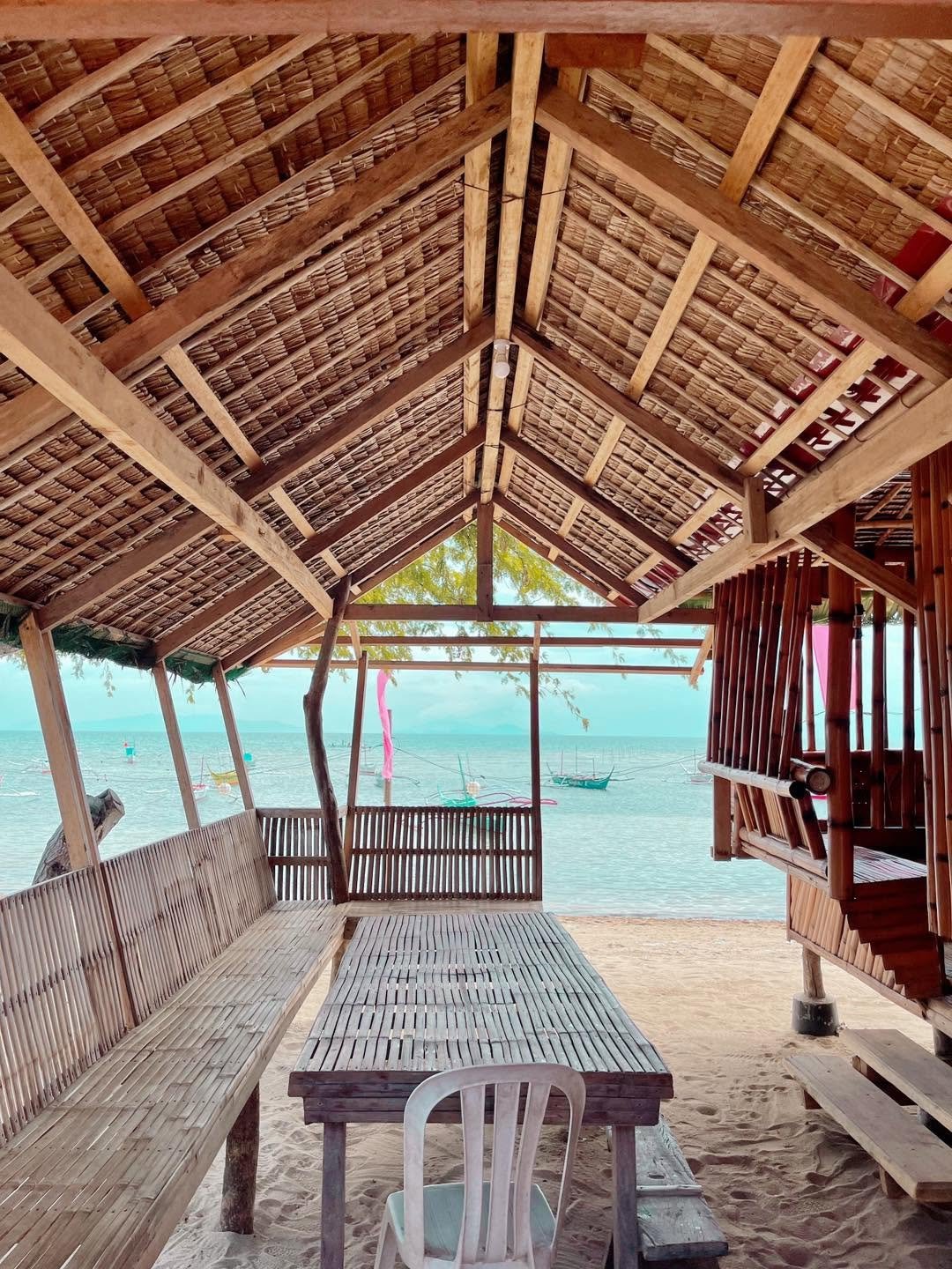 Covered bamboo seating overlooking the beach at Camp Wagi