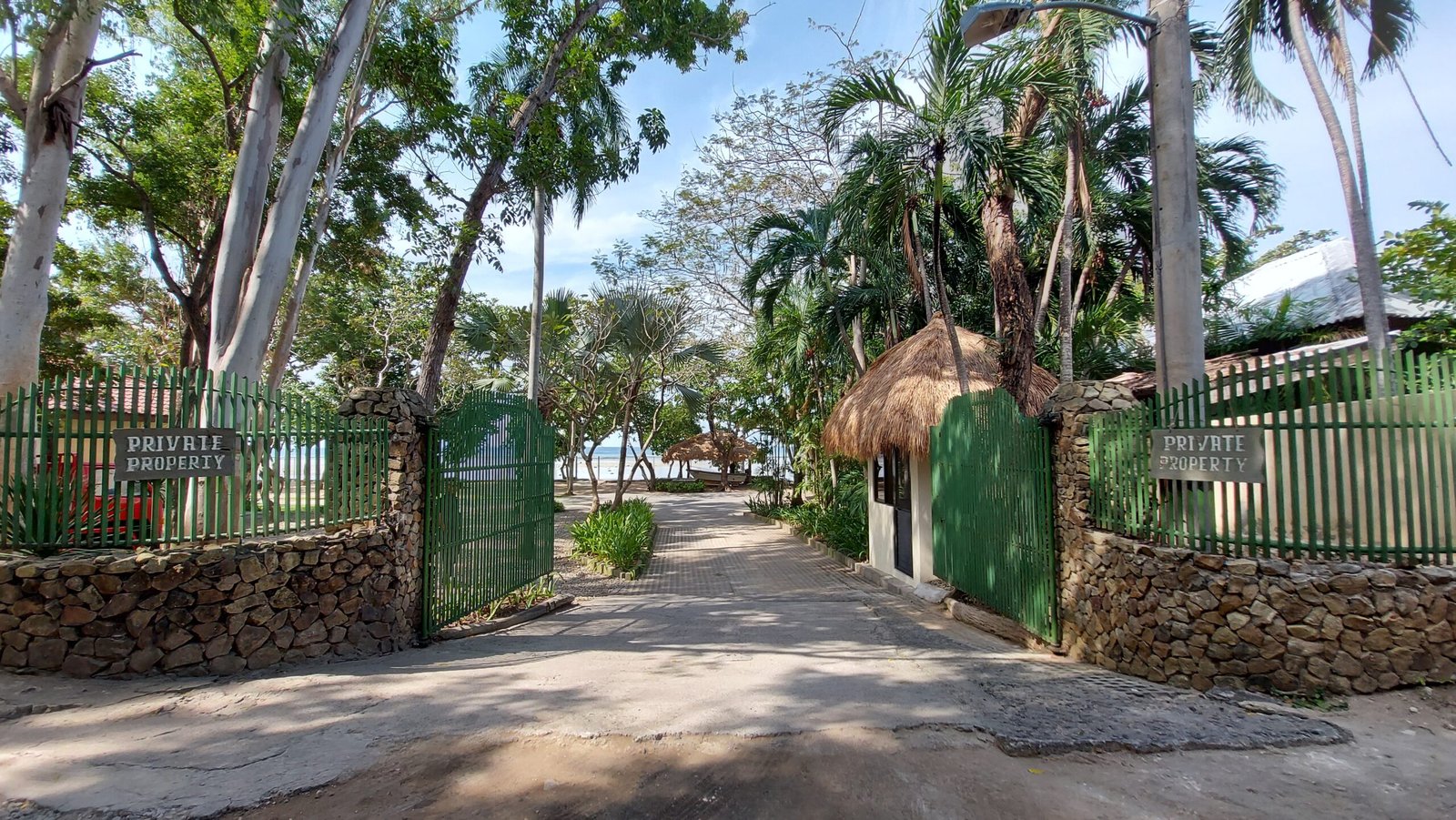 Casa Bu entrance gate with a view toward the beachfront grounds