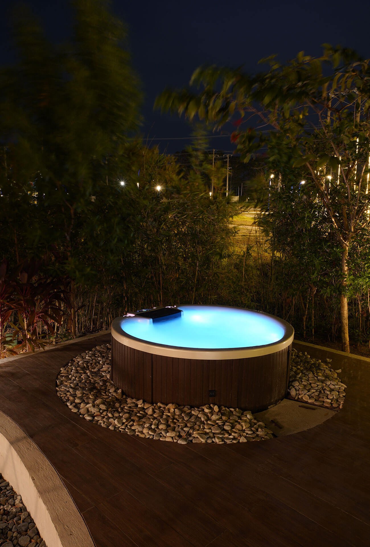 Illuminated private outdoor jacuzzi beside a Cupola suite