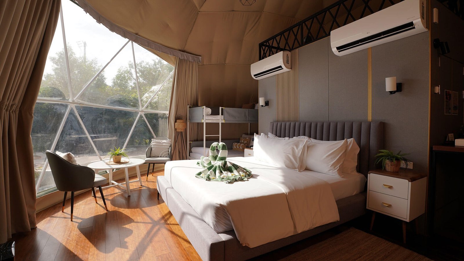 King bed, bunk bed and lounge inside a Cupola dome suite