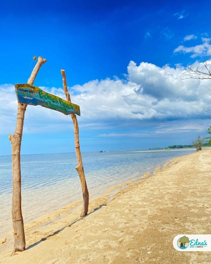 Edna's Beach and Campsite sign beside the sandy shoreline