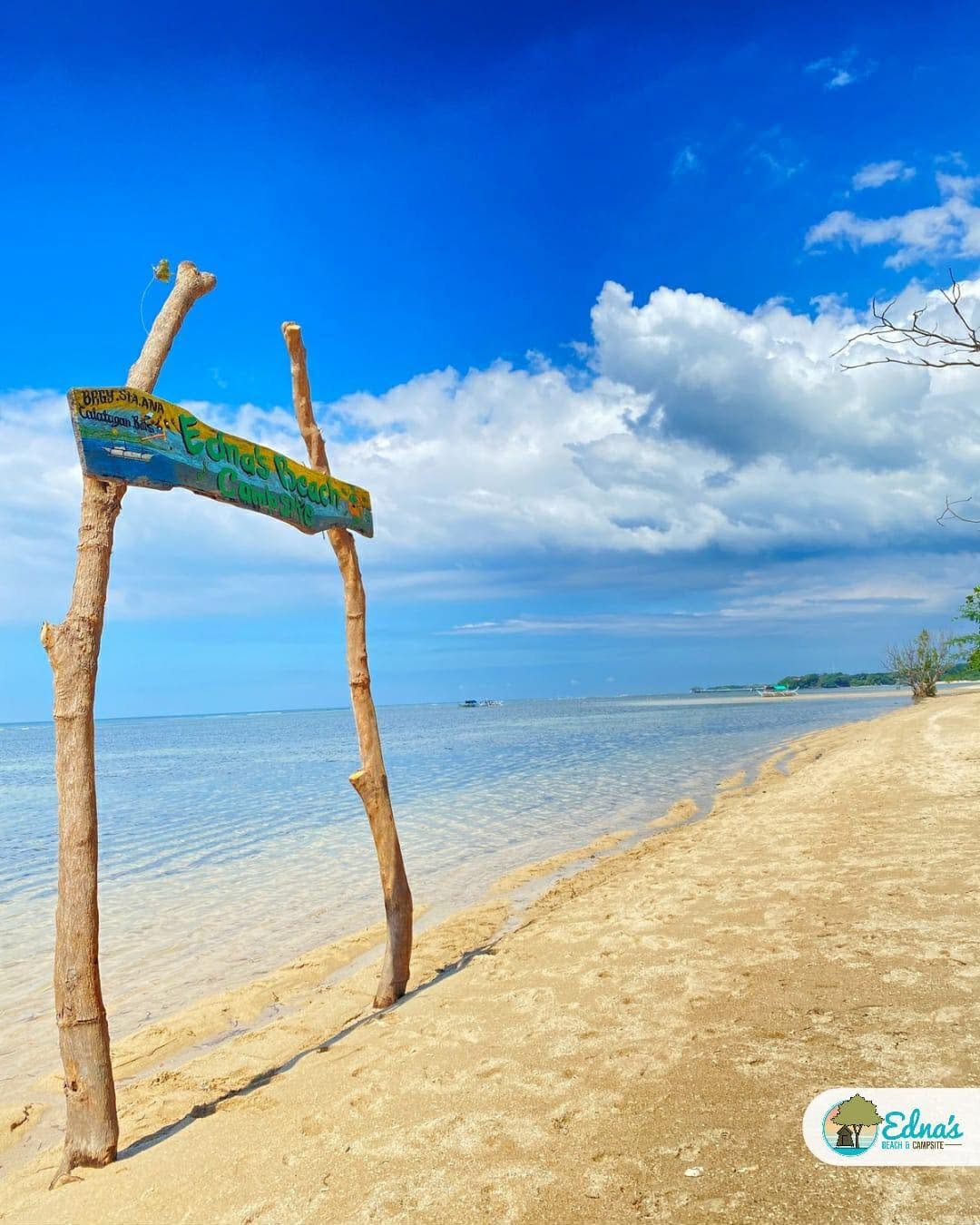 Edna's Beach and Campsite sign beside the sandy shoreline