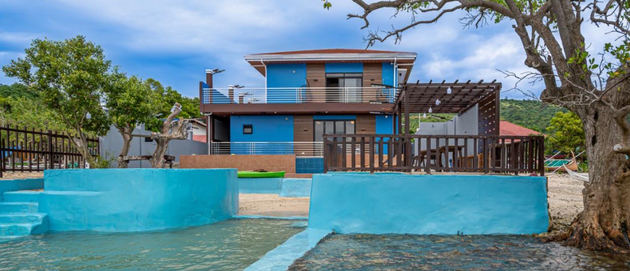 Our Hideaway Beach Resort house exterior viewed from the waterfront