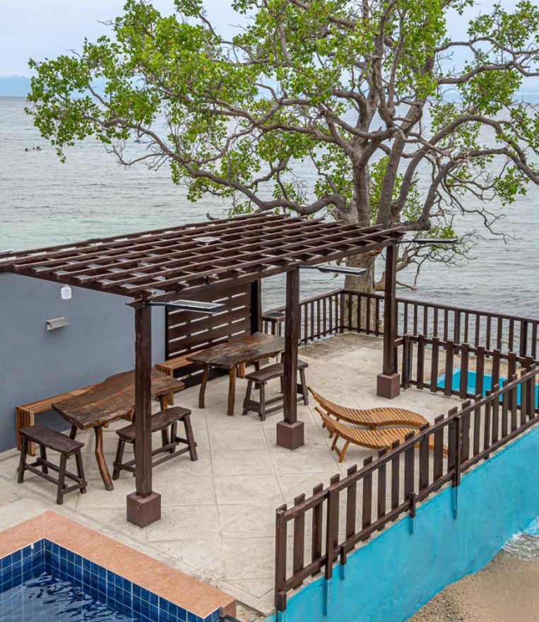Seafront outdoor lounge beside the pool at Our Hideaway Beach Resort