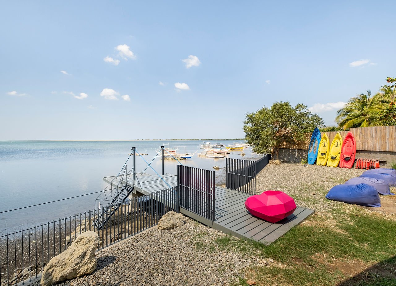 Seafront deck and kayaks at Tirta Cottages in Calatagan