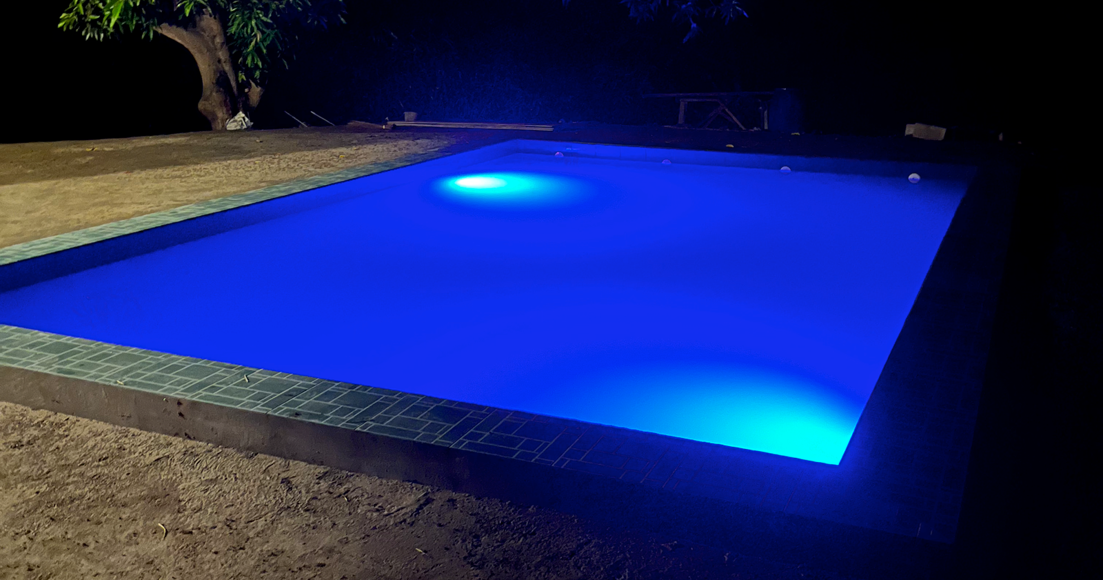 Swimming pool and landscaped seating area at Unwind Calatagan Leisure Farm